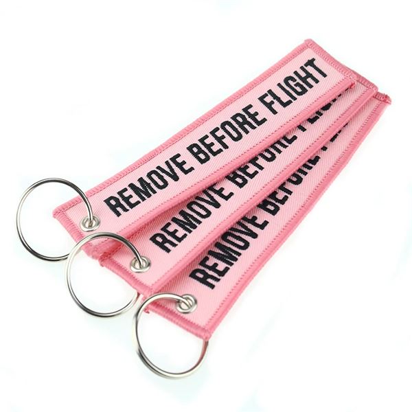 Keyring REMOVE BEFORE FLIGHT light pink